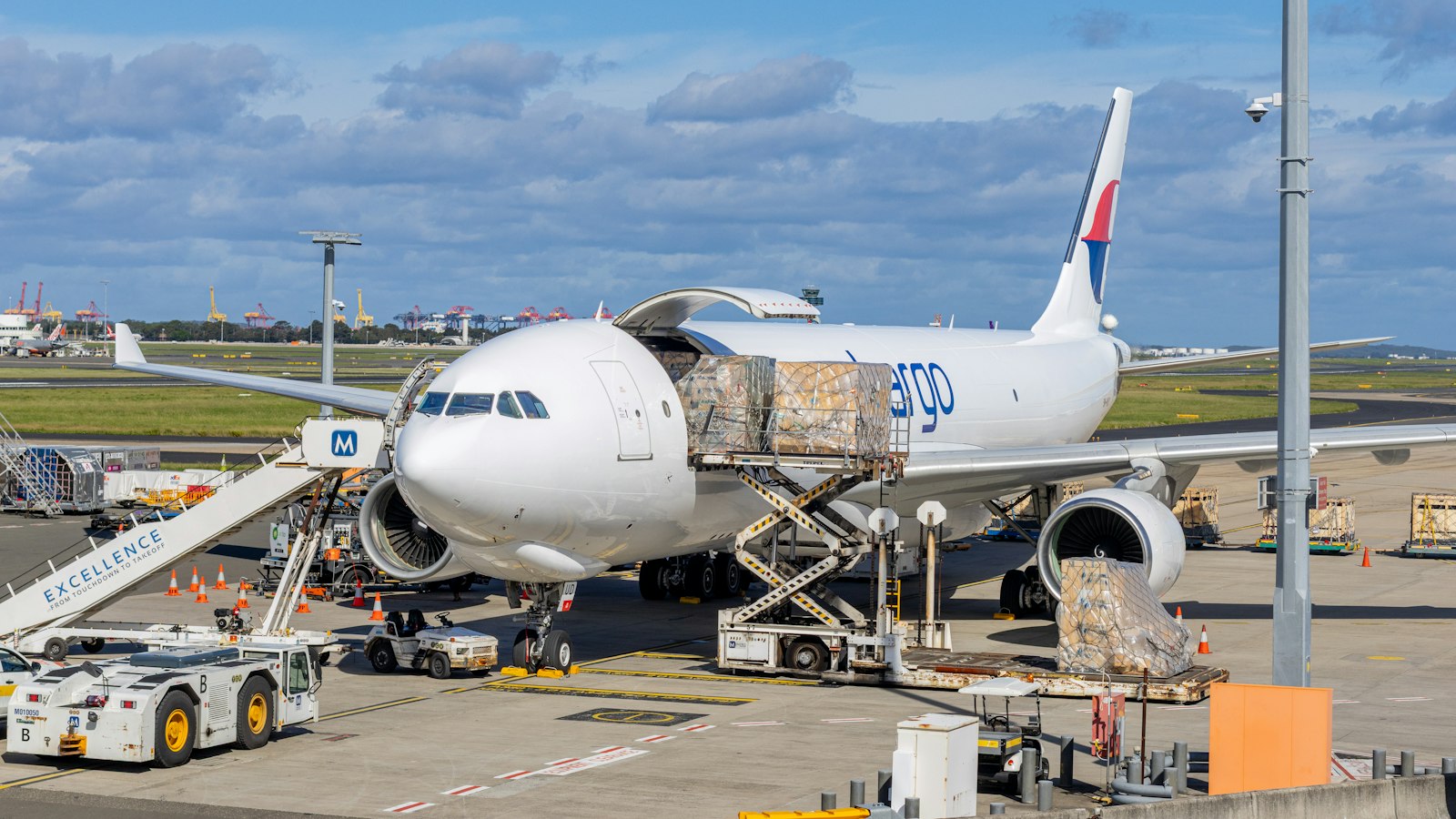 Cargo plane being loaded at an airport tarmac